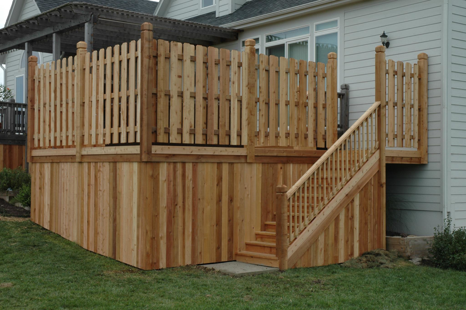 A newly built wooden deck with stairs and a privacy fence installed by Holm Remodeling Company in Kansas City, KS.