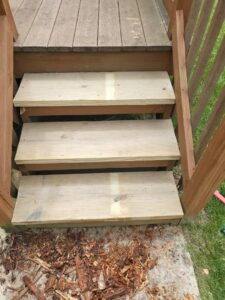 Newly installed wooden steps on a deck or outdoor stairs by Green Man's Contracting & Landscaping LLC in West Hartford, CT.