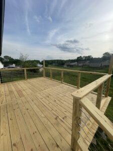 A newly constructed wooden deck featuring modern cable railings, built by Richwood Remodeling & Outdoor in Nashville, TN.