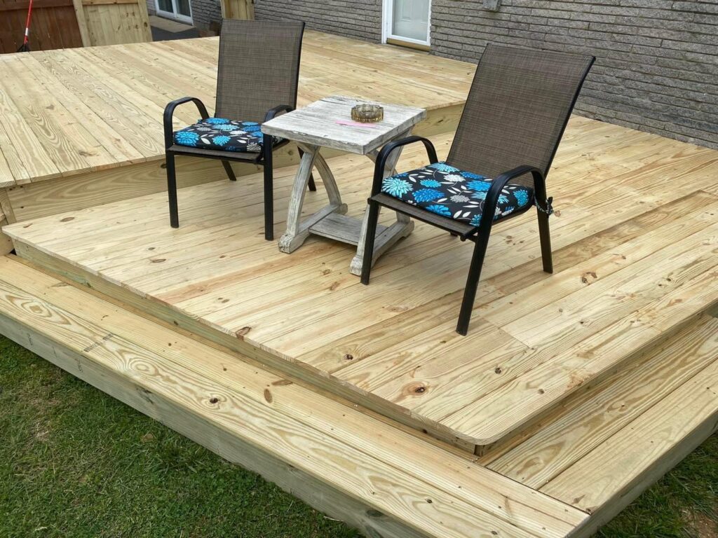 A newly built wooden deck featuring two patio chairs and a small table, completed by Richwood Remodeling & Outdoor in Nashville, TN.