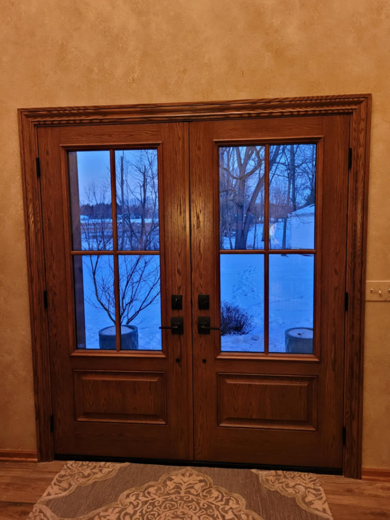 Interior view of newly installed wooden double doors by 1st Choice Windows, serving Canton, OH.