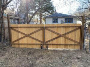 Newly installed wooden double gate with decorative X-bracing, a fence and gate service by No Delay SVCS in Pocatello, ID.
