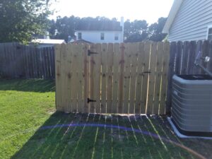 A newly installed wooden fence gate, a handyman service by Holy City Remodel in North Charleston, SC.