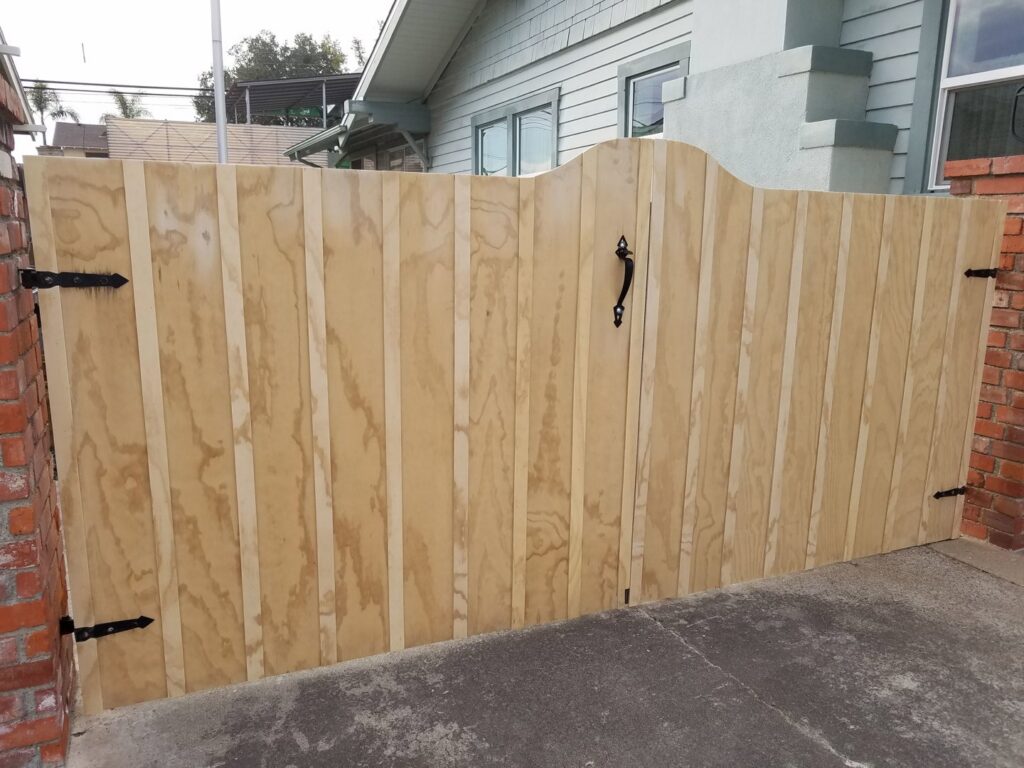 A newly installed custom wooden gate with black hardware by Barry's Handyman Service in San Diego, CA.
