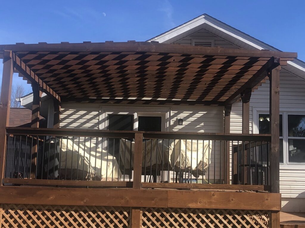 A newly constructed wooden pergola over a deck, built by HandyVets in Saint Charles, MO.