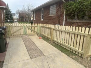 A new wooden picket fence and gate installed by Ofandiski Fence Co. Inc in Lorain, OH.