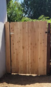 A newly installed wooden picket fence gate for a home in Fresno, CA, completed by My Quality Handyman.