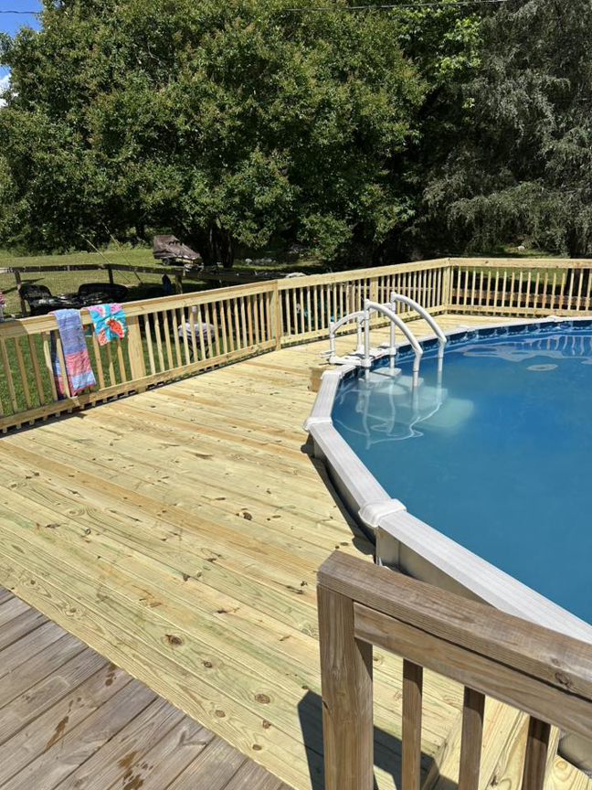 A newly installed wooden deck surrounding an above-ground pool by Fence&Wash in Rock Hill, SC.