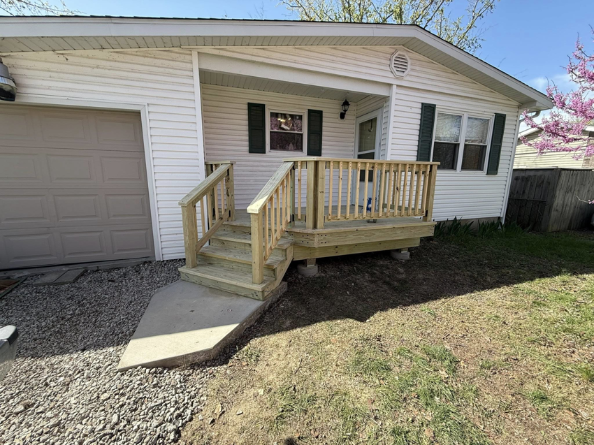 A newly installed wooden porch and deck at a home by Naugle Construction Company in Columbia, MO.
