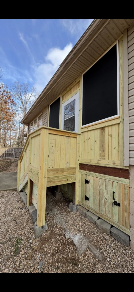 A newly constructed wooden porch and stairs on a house exterior, completed by Screw it, Call Rod in Rogers, AR.