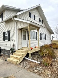 A newly constructed wooden porch and stairs on the exterior of a house by Northeast SD Handyman in Watertown, SD.