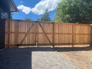 A newly installed wooden privacy fence with a matching gate by GreenView Solutions in Denver, CO.