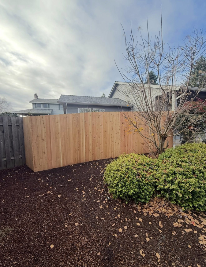A newly installed wooden privacy fence by Reborn Construction LLC in Wilsonville, OR.