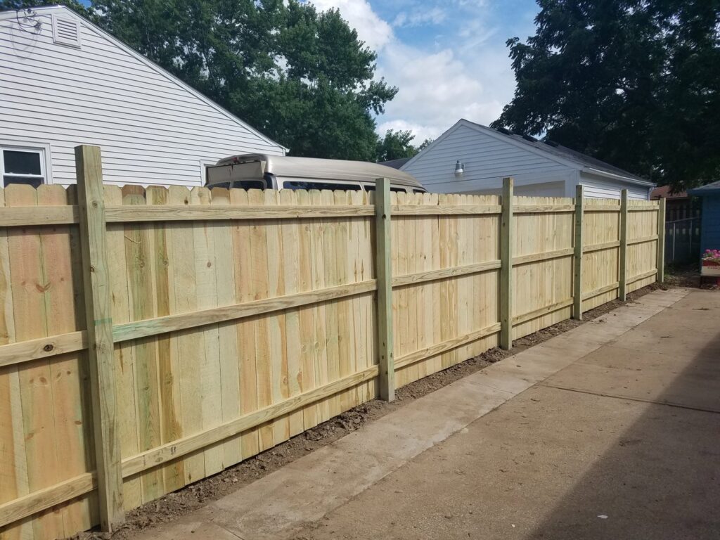 A newly installed wooden privacy fence by Rosewalls Handyman & Remodeling in Des Moines, IA.