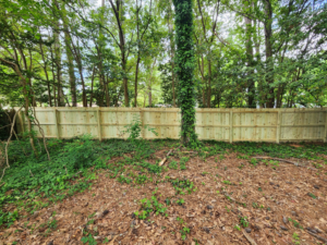 A newly installed wooden privacy fence in a backyard by Top Ace Handyman Services in Atlanta, GA