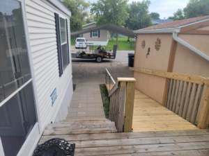 A newly installed wooden ramp and stairs leading to a mobile home, completed by Becker Services ND in West Fargo, ND.