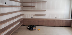 New wooden shelves and cabinet installation in a room by CCS Tulsa, OK