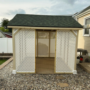 A newly built backyard gazebo with a dark green roof and white lattice sides by Imagine It Home Improvements Co. in Bethlehem, PA.