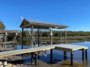 A newly built boat dock and covered boat lift structure over water, completed by Bayside Concrete & Construction in Tampa, FL