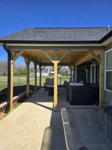 A newly built covered patio or porch extension attached to a home by IWork Home Services in Greensboro, NC.