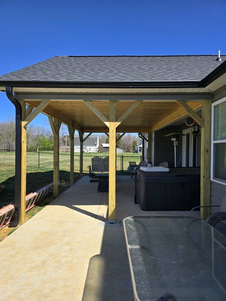 A newly built covered patio or porch extension attached to a home by IWork Home Services in Greensboro, NC.