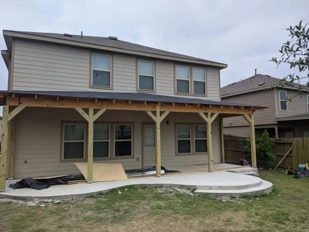A newly built covered patio and concrete slab extension on a residential home by Morin Construction LLC in San Antonio, TX