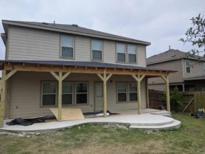 A newly built covered patio and concrete slab extension on a residential home by Morin Construction LLC in San Antonio, TX