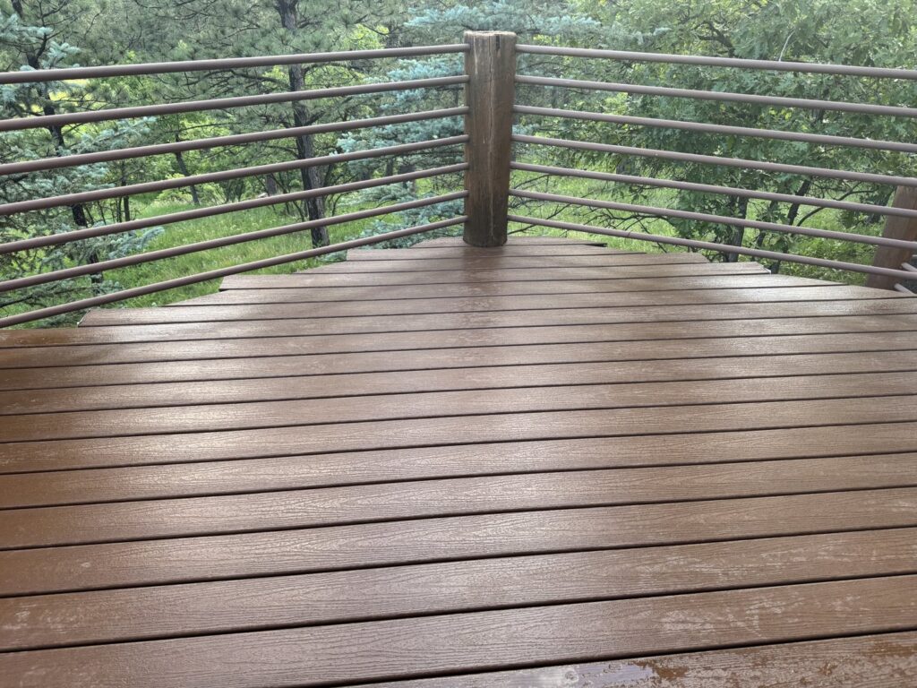 A newly built outdoor deck with metal railings, completed by Ace Handyman Services in North Kingstown, RI