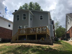 A newly built wooden deck and retaining wall on the exterior of a house by DSD Construction in Saint Louis, MO.