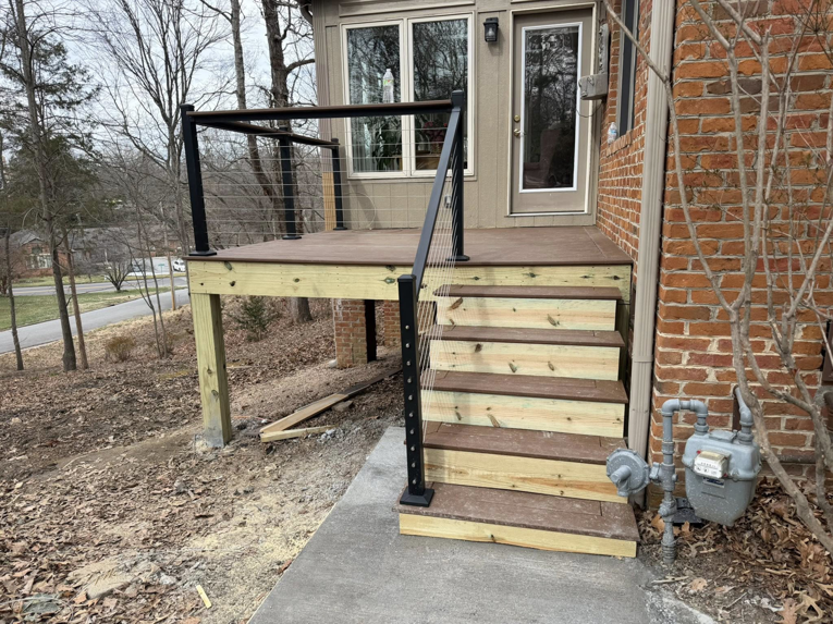 Side view of a newly built deck with wooden stairs and cable railings by IWork Home Services in Greensboro, NC.