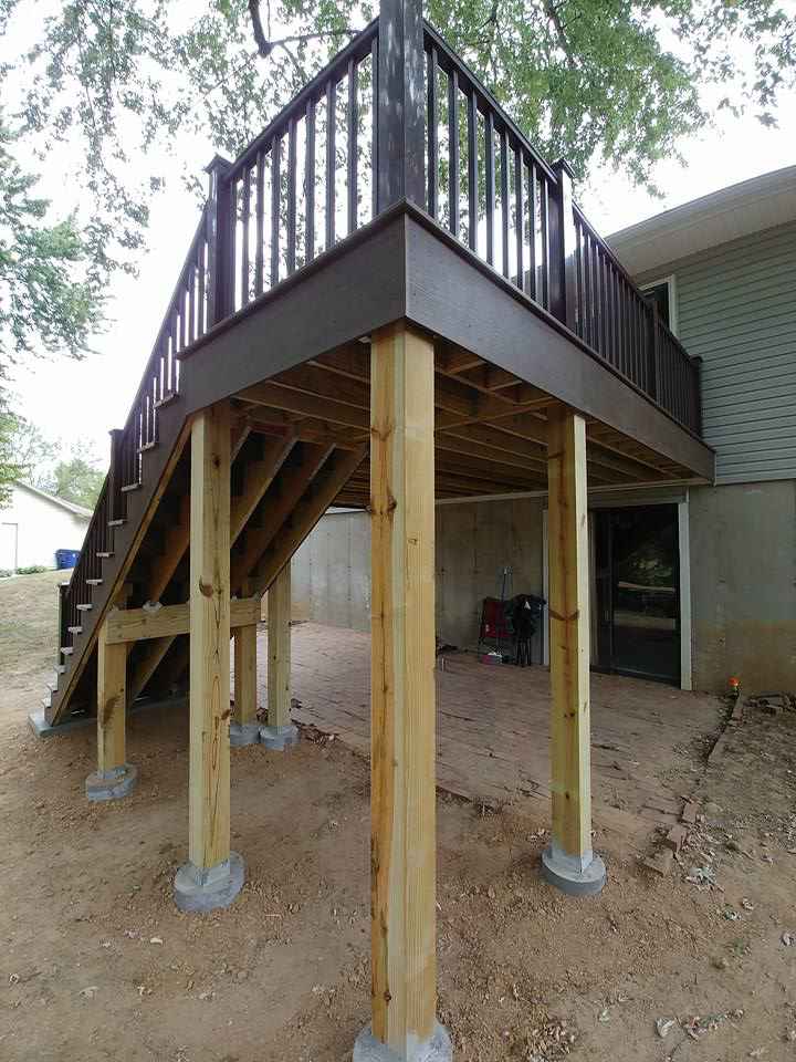 A newly constructed outdoor deck showing its wooden support structure and stairs, built by Custom Remodeling Inc. in Houston, TX.
