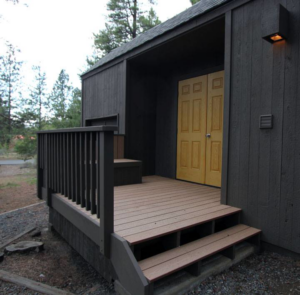 A newly built exterior wooden deck and steps leading to a building by Winch Construction in Bend, OR.