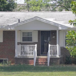 A newly constructed front porch with white railings on a brick house by B & L Builders in Jonesborough, TN