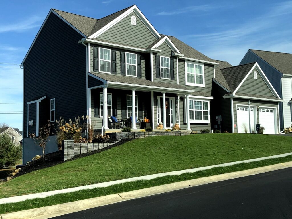A beautiful newly built home with gray siding and white trim, showcasing quality construction by Lancaster Home Builders in Lancaster, PA.