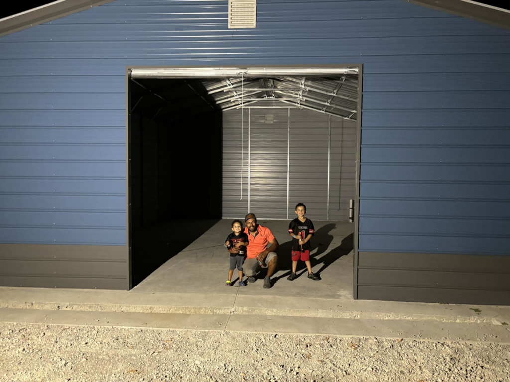 A newly built blue metal garage or workshop, a construction project by DELM Construction & Remodeling LLC in Evansville, IN.