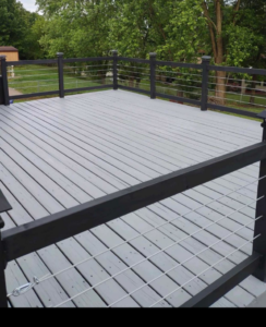 A newly constructed outdoor deck with modern grey planks and black cable railings by Berling Remodeling llc in Highland Heights, KY.