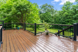 A newly built outdoor deck with dark wood planks and black railings by Total Craftsmen in Towson, MD