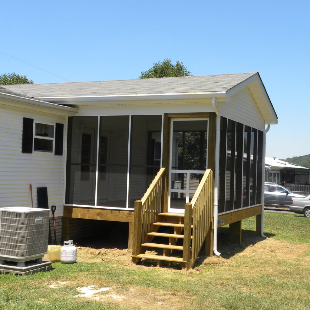 A newly constructed screened porch with wooden stairs and railings by B & L Builders in Jonesborough, TN