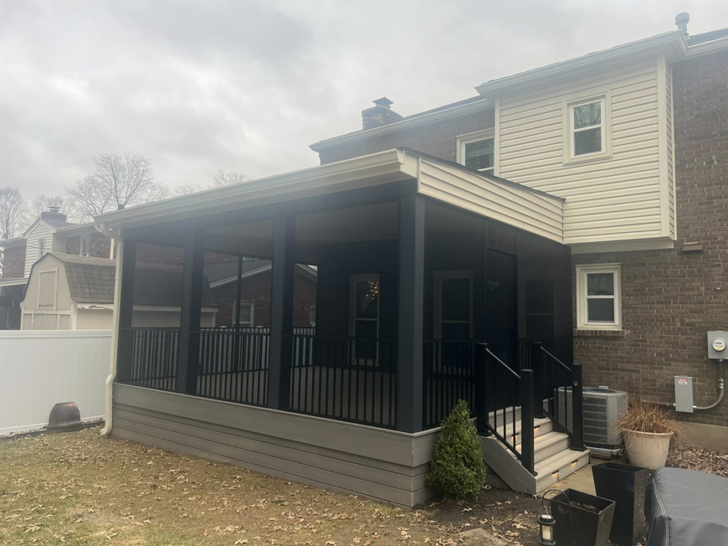 A newly built screened-in porch and deck exterior by Decks Unlimited, a handyman service in Littleton, CO.