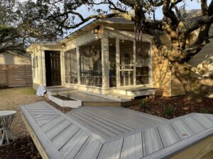 A newly constructed screened porch and multi-level composite deck for a home by Seaside Craftworks LLC in Wilmington, NC.
