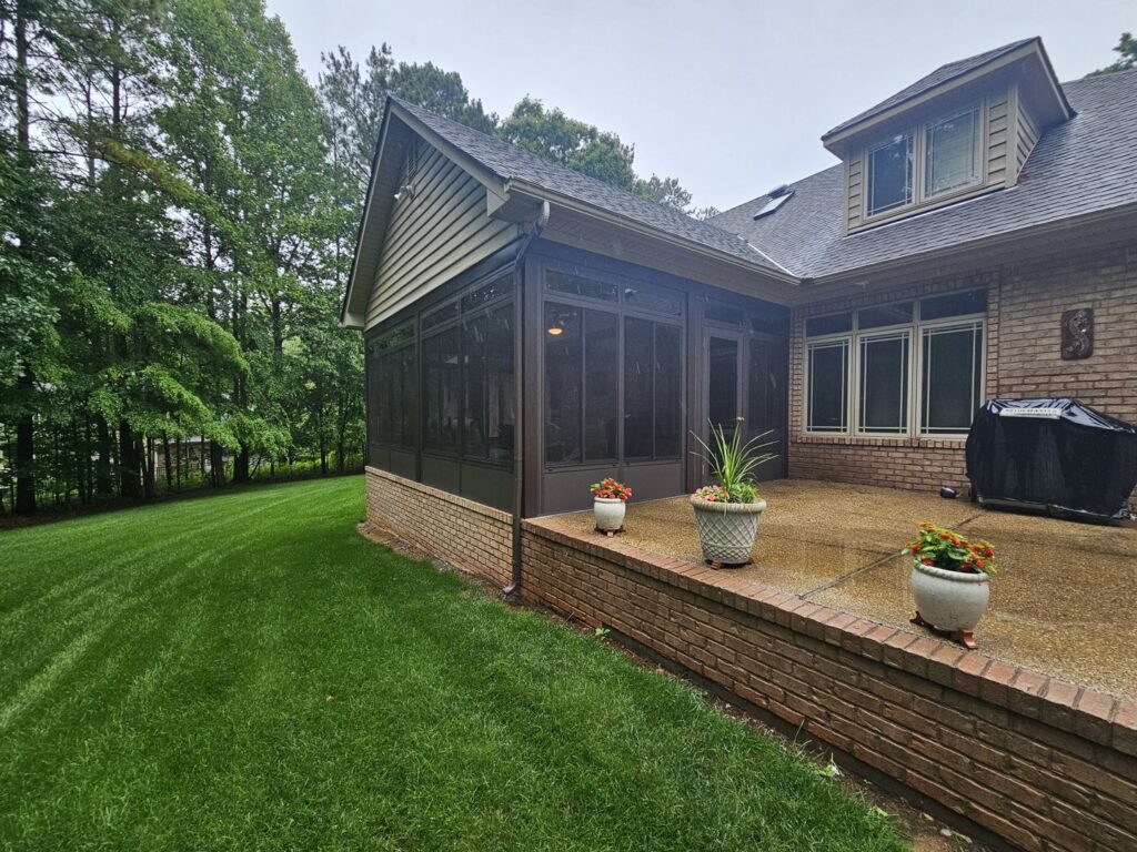 A newly built screened porch addition on the exterior of a home by X-Terior Techs in Henrico, VA.