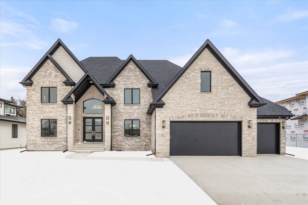 A newly built stone and brick home exterior by Overstreet Builders, Inc. in Naperville, IL.