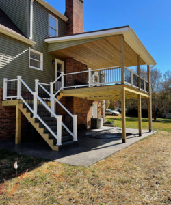 A newly built two-story deck with stairs and white railings by Pineda's Construction LLC in Colorado Springs, CO