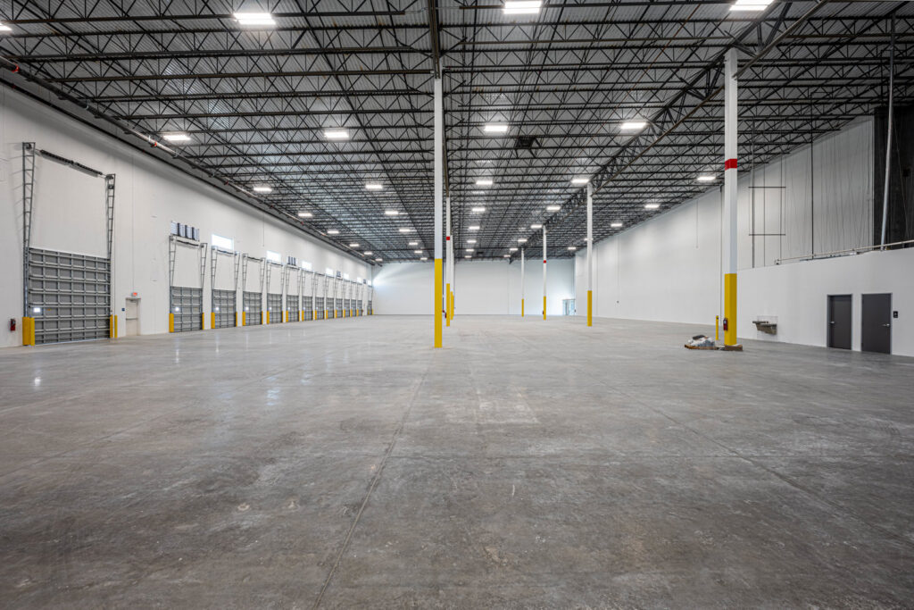 Interior of a newly built or renovated large warehouse facility by Hernandez Construction & Development in Fort Lauderdale, FL.