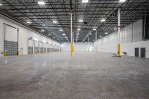 Interior of a newly built or renovated large warehouse facility by Hernandez Construction & Development in Fort Lauderdale, FL.