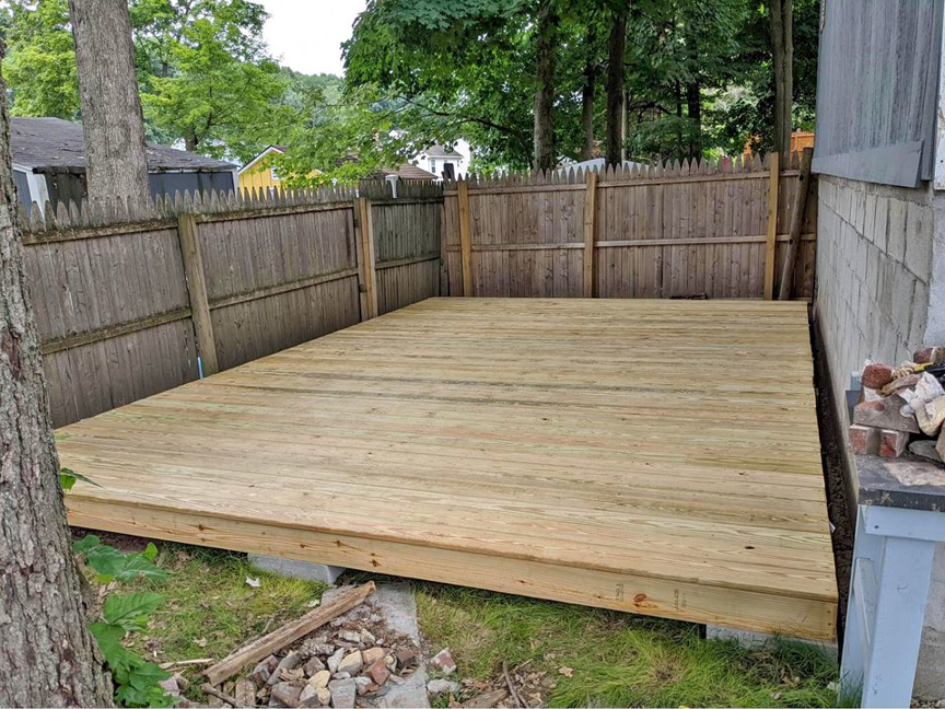 A newly built wooden deck installed in a backyard by All Service Group LLC in San Jose, CA