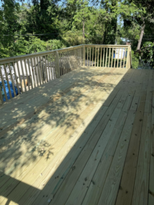 A newly built wooden deck with railings, constructed by AC Fence and Ironworks in Philadelphia, PA.
