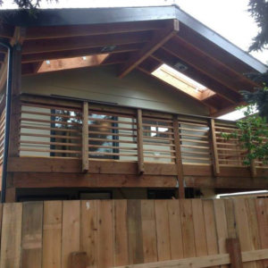 A newly built wooden deck and balcony on a house exterior by Fine Hand LLC in Portland, OR