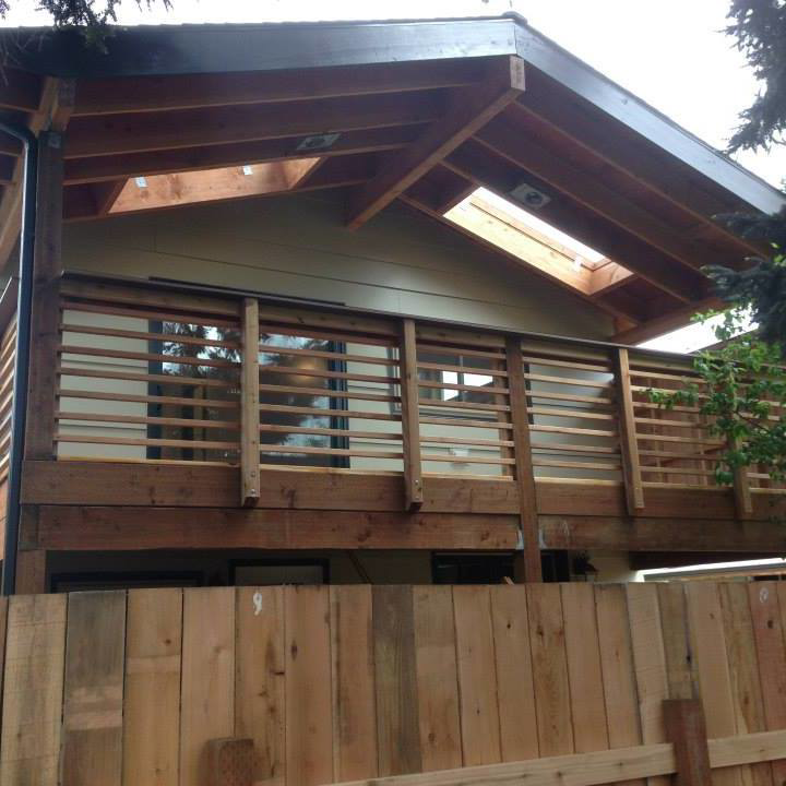 A newly built wooden deck and balcony on a house exterior by Fine Hand LLC in Portland, OR