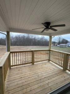 A newly built wooden deck with a white ceiling fan installed, showcasing handyman work by Pingleton Contracting in Richmond, KY.